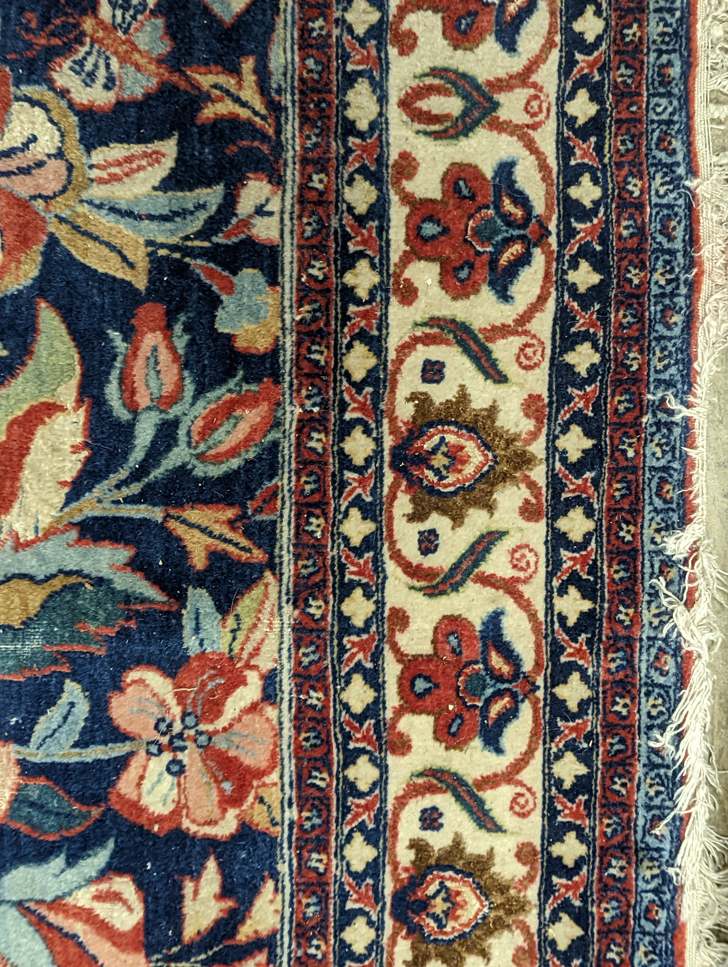 A Kirman blue ground rug woven with birds amongst flowering branches, 205 x 136cm